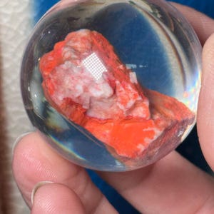 Cinnabar on quartz matrix  safely sealed in resin sphere