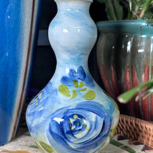 Hand painted under glaze porcelain vase with blue flowers