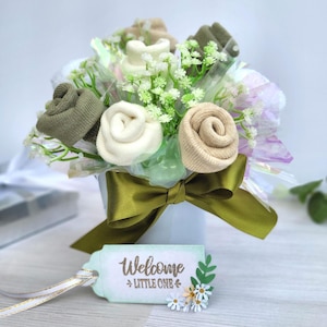 May include: A rustic wooden sign with the text "Welcome to our home" in white lettering. The sign features a distressed finish and a simple, inviting design, perfect for a front porch or entryway.
