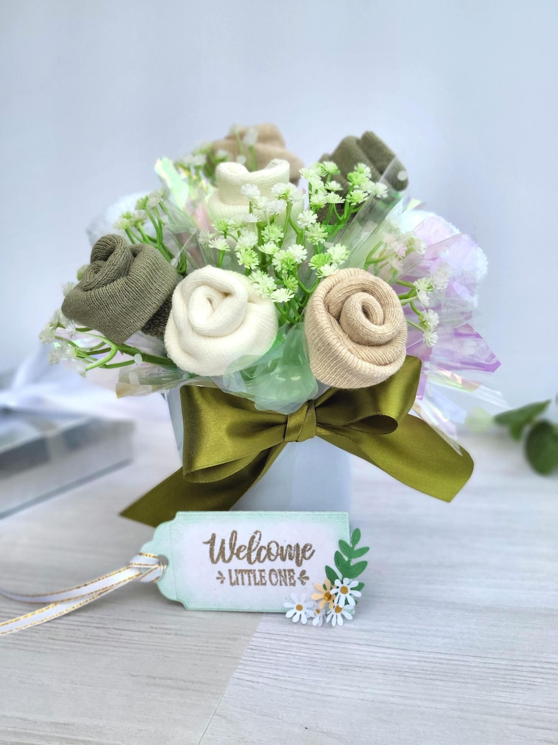 May include: A rustic wooden sign with the text "Welcome to our home" in white lettering. The sign features a distressed finish and a simple, inviting design, perfect for a front porch or entryway.