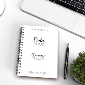 May include: White spiral bound order book with the text "Order Book" and the logo "Memories Givers Handmade Boutique" with a gift box and heart graphic.