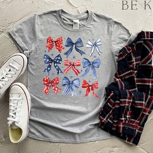 a pair of sneakers and a t - shirt with bows