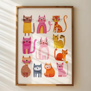 May include: A framed art print featuring a collection of whimsical cat illustrations. The cats are depicted in various colors and patterns, including pink, orange, yellow, and brown. Each cat has a unique design, with some featuring stripes, hearts, and rainbows.