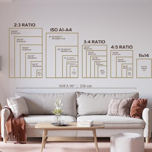 May include: A wall-mounted chart displays print sizes in various ratios, including 2:3, ISO A1-A4, 3:4, 4:5, and 11x14, with measurements in inches and centimeters. A sofa, 90 inches (228 cm) wide, is positioned below the chart, with decorative pillows and a throw.