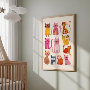 May include: A framed art print featuring a collection of colorful, cartoon cats. Each cat has a unique design, with various patterns and colors, including pink, orange, yellow, and brown. The artwork is displayed in a light-colored wooden frame, suitable for a nursery or child's room.