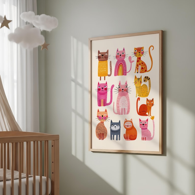 May include: A framed art print featuring a collection of colorful, cartoon cats. Each cat has a unique design, with various patterns and colors, including pink, orange, yellow, and brown. The artwork is displayed in a light-colored wooden frame, suitable for a nursery or child's room.