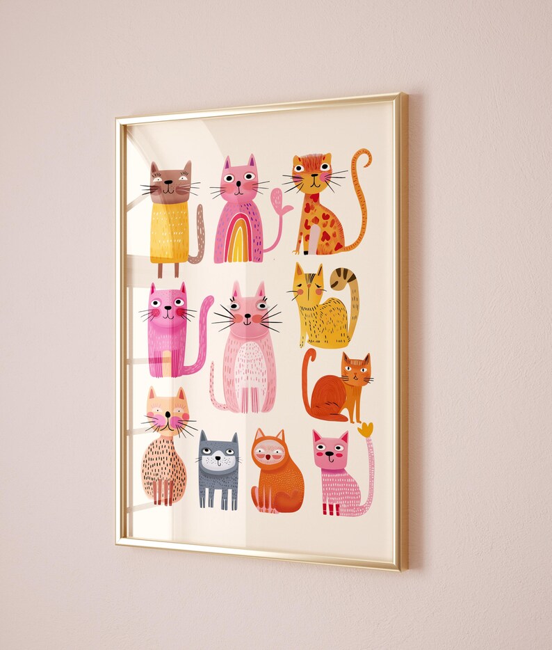 May include: A framed art print featuring a collection of whimsical cat illustrations. The cats are depicted in various colors, including pink, orange, and yellow, with unique patterns and expressions. The artwork is set against a cream background and framed in a gold-colored frame.