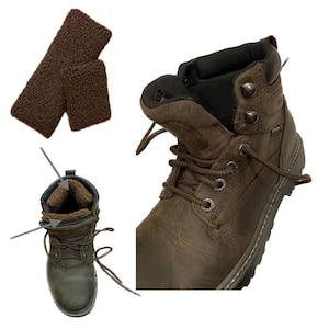 May include: A brown leather ankle boot with a dark brown faux-shearling lining, metal eyelets, and brown laces. The boot features a padded collar and a textured sole. Two separate rectangular pieces of brown faux-shearling fabric are also shown.