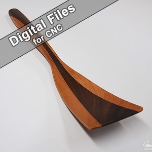 May include: Wooden spatula with a light brown and dark brown striped design. The spatula has a wide, angled head and a long, slender handle. Text on the image reads "Digital Files for CNC".