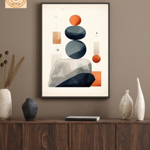 May include: Abstract geometric wall art print with a white background, featuring stacked blue and gray circles, orange and red circles, and orange and beige rectangles. The print is framed in black and has the text "Be Your Wall heArt" at the bottom.