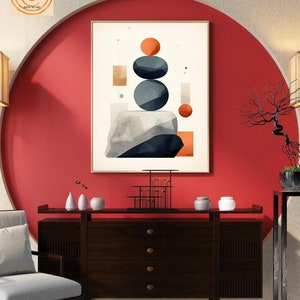 May include: Abstract geometric wall art print with a red, orange, gray, and white color scheme. The print features a stack of three gray circles, a red circle, and a few rectangles. The print is framed and hanging on a red wall.