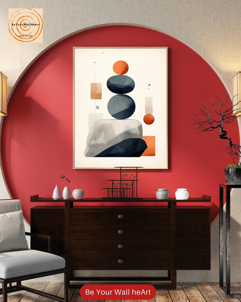 May include: Abstract geometric wall art print with a red, orange, gray, and white color scheme. The print features a stack of three gray circles, a red circle, and a few rectangles. The print is framed and hanging on a red wall.