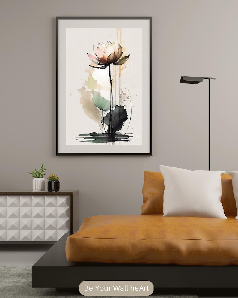 May include: A watercolor painting of a pink and white lotus flower with green leaves and a black stem. The background is a light brown with splashes of green and black.