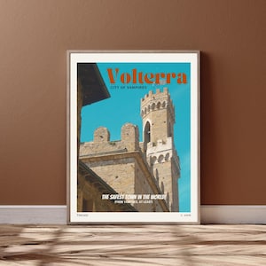 May include: A vintage travel poster for Volterra, Italy, a city known as the "City of Vampires." The poster features a photo of a medieval tower and the text "The Safest Town in the World! (From Vampires, at Least)"