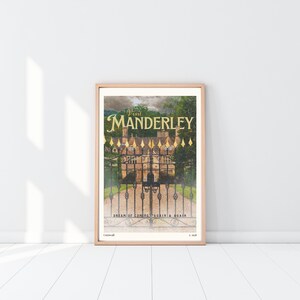 May include: A vintage-style poster featuring a photograph of a large, stone house with a black iron gate in front. The text on the poster reads "Visit Manderley" in gold lettering. The poster also includes the text "Dream of coming again & again" and "Cornwall" in smaller lettering.