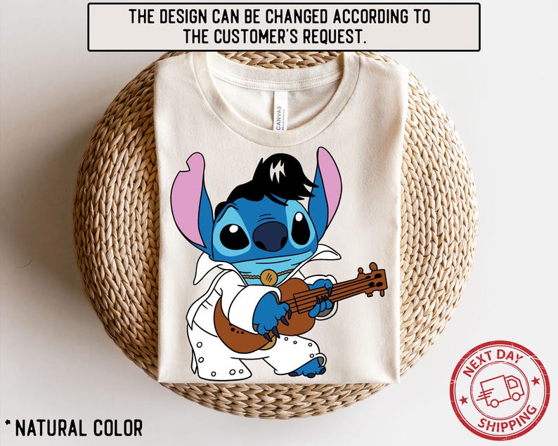 May include: A white t-shirt with a blue cartoon character playing a guitar. The character is wearing a white suit and has a blue mohawk. The text "CANVAS" is visible on the shirt.