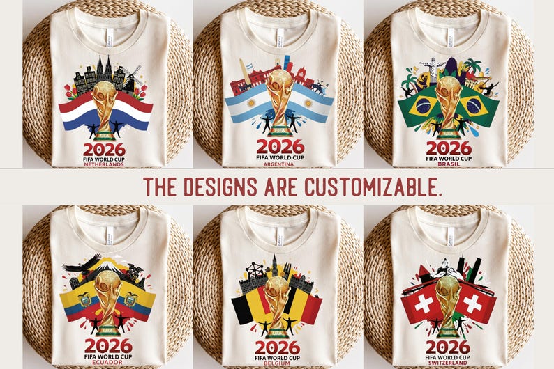 May include: A collection of cream-coloured t-shirts, each showcasing a FIFA World Cup 2026 design. The shirts display a golden trophy, flags, and cityscapes representing the Netherlands, Argentina, Brazil, Ecuador, Belgium, and Switzerland. Text: "THE DESIGNS ARE CUSTOMIZABLE."