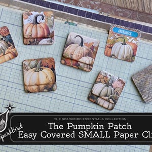 May include: A set of six small paper clips with autumn-themed designs featuring pumpkins, leaves, and the words "Abundance" and "Golden 85". The paper clips are part of the Sparkbird Essentials Collection and are labeled "The Pumpkin Patch Easy Covered SMALL Paper Clips".