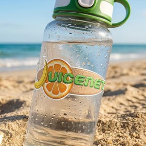 May include: A clear plastic water bottle with a green lid and a sticker featuring a yellow banana, an orange slice, and the text JUICENET. The bottle is covered in water droplets, showing a transparent body and a functional flip-top cap design.