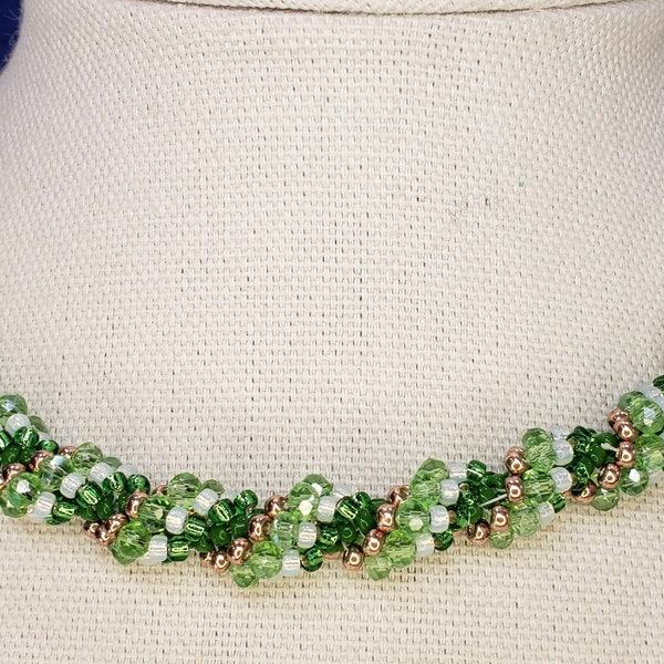 Hand stitched green crystal, white, green and gold seed bead choker. Crystal encrusted magnetic clasp, the ultimate in arthritis friendly!