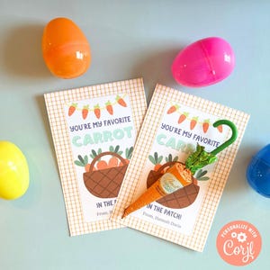 May include: Two Easter cards with a carrot theme. The cards are decorated with a checkered pattern and feature the text "You're my favorite carrot in the patch!" One card has a carrot with a green leafy top and a blue umbrella. The other card has a basket of carrots.