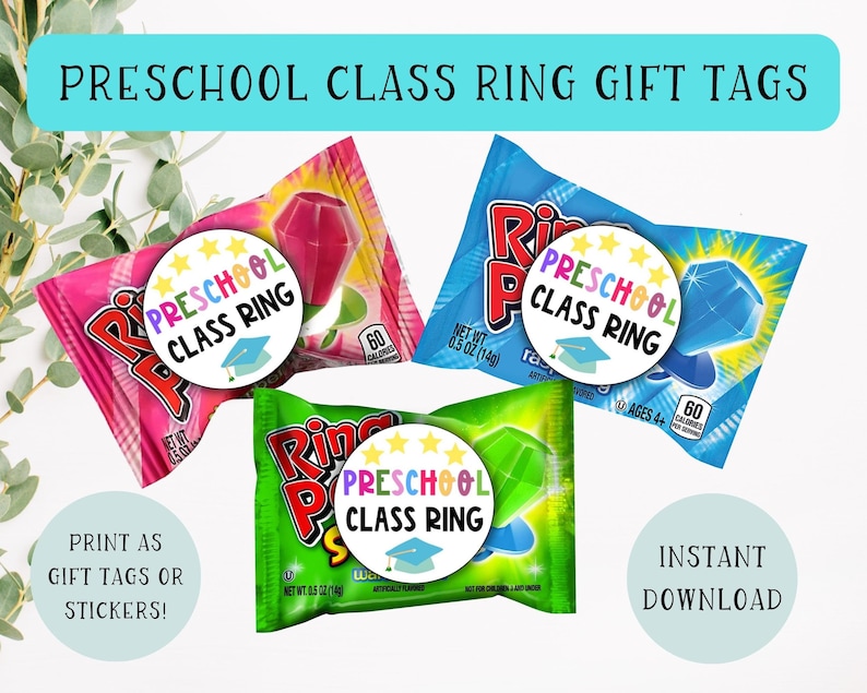 May include: Three printable gift tags featuring a colorful ring pop candy wrapper with a circle sticker that says "Preschool Class Ring" with stars and a graduation cap. The tags are designed to be printed as gift tags or stickers.