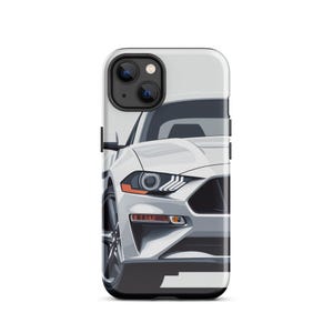 May include: A white phone case featuring a stylized illustration of a white sports car. The car has black wheels, orange headlights, and a black grille. The phone case has a black camera module.