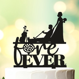 May include: Black silhouette cake topper of a bride and groom with a golf cart and golf clubs. The text "FOREVER" is written below the couple with a golf ball in the "O".