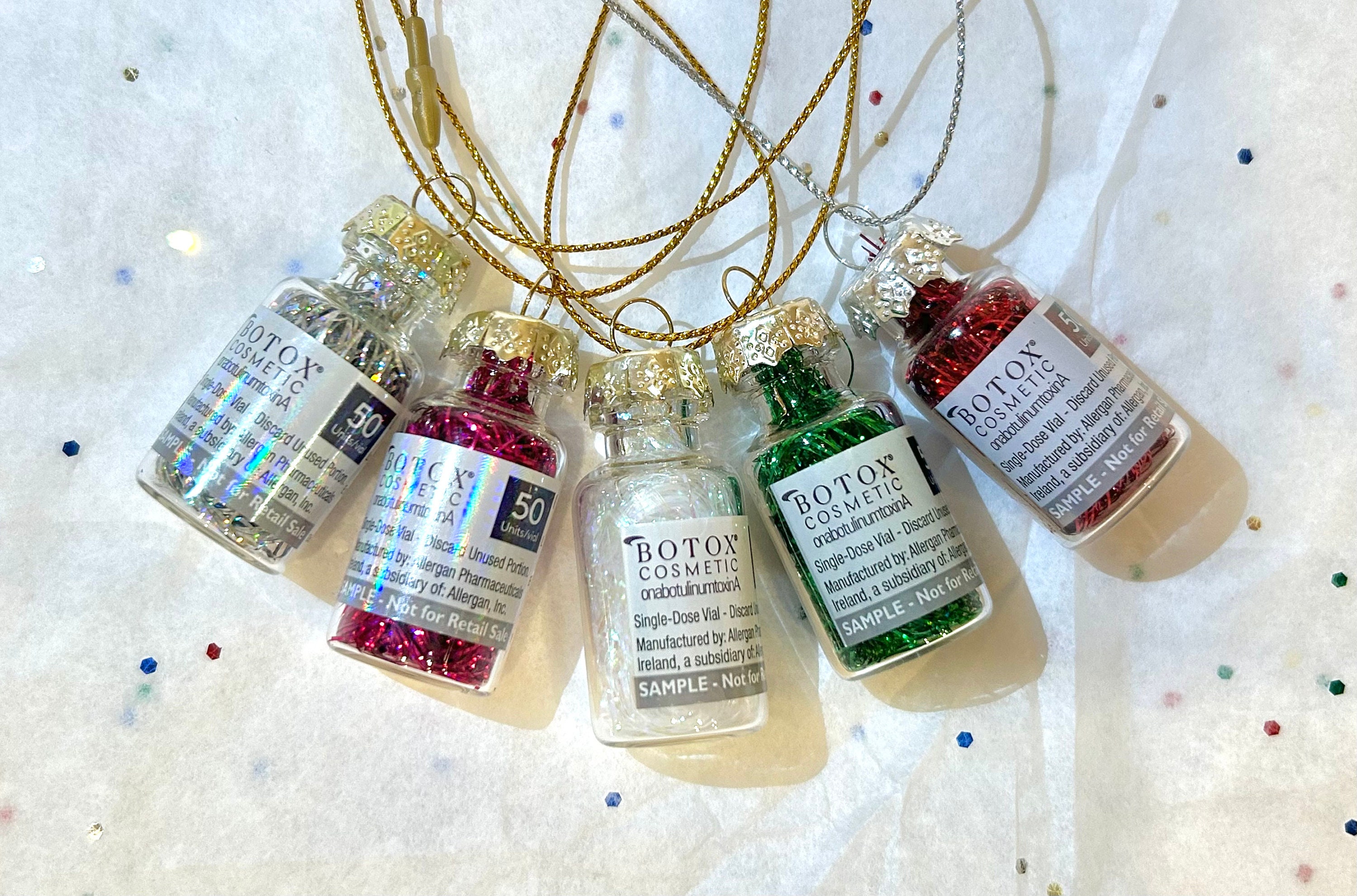 Upcycled medication vials into tiny Christmas ornaments to