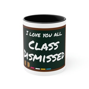 May include: White ceramic mug with a black rim. The mug features a green chalkboard design with the text "I love you all. Class Dismissed." in white.