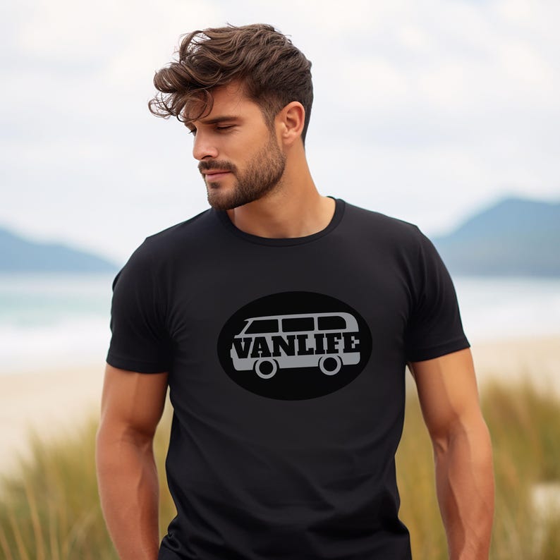 A man in a black t-shirt with a black embellishment featuring a graphic of a van that reads VAN LIFE