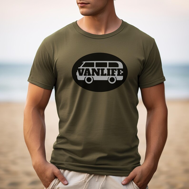 A man in a military green t-shirt with a black embellishment featuring a graphic of a van that reads VAN LIFE