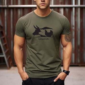 May include: A green t-shirt with a black silhouette of a cow and a chicken with the text "Carnivore Life" printed on the front.