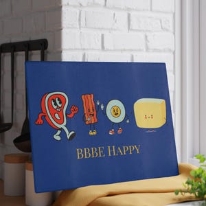 May include: Blue cutting board with a cartoon illustration of a steak, bacon, egg, and butter. The characters are smiling and waving. The text "BBBE HAPPY" is printed in gold below the characters.