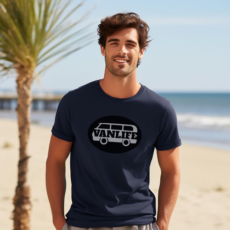 A man in a navy t-shirt with a black embellishment featuring a graphic of a van that reads VAN LIFE