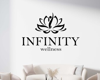 May include: A white couch with two white armchairs in front of a white wall. The wall has a black logo with a stylized lotus flower and the text "INFINITY wellness".