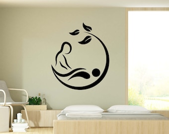 May include: Black and white silhouette wall decal of a person receiving a massage. The decal is in the shape of a circle with leaves at the top.