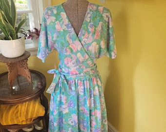 Late 1970's Impromptu Teal Wrap dress in pink and purple floral with pleated details on neckline. Bust 38" - Waist 30". Size 8 US.