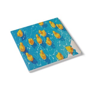 May include: A square ceramic coaster with a design of yellow rubber ducks in a blue pool. The ducks are arranged in a pattern, with shadows suggesting sunlight. The coaster has a white border. The measurements are in centimetres.