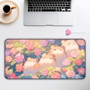 May include: A mousepad with a floral design featuring pink, yellow, and white flowers. Four cartoon hamsters are nestled among the flowers. The hamsters are light brown and have pink cheeks.