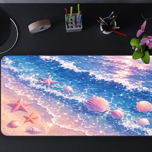 May include: A rectangular desk mat featuring a beach scene with blue water, pink seashells, and starfish. The mat has a smooth surface and is designed to protect the desk from scratches. The mat is surrounded by office supplies and a cup of coffee.