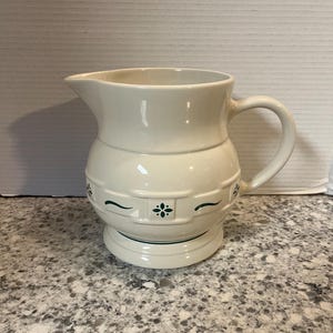 May include: A set of three ceramic mugs with a speckled, matte finish. Each mug features a different color: light blue, cream, and gray. The mugs have a simple, modern design and a comfortable handle.