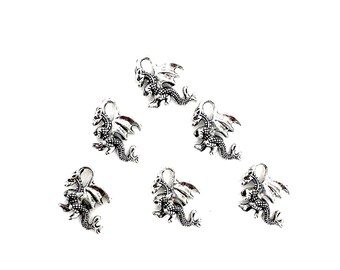 May include: Six silver dragon charms with intricate details. The charms are perfect for adding a touch of fantasy to jewelry or crafts.