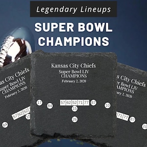 a pair of football shoes sitting on top of a black stone