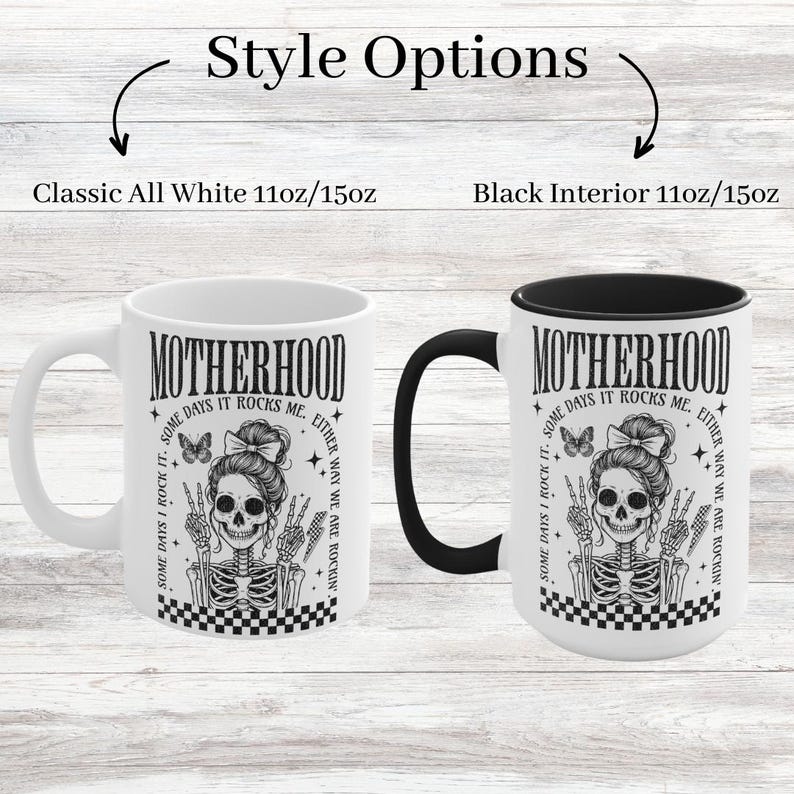 May include: White ceramic mug with a black interior and a black and white graphic of a skeleton with the text "Motherhood Some Days I Rock It. Some Days It Rocks Me. Either Way We Are Rockin'" printed on it. The mug is available in two sizes: 11oz and 15oz.