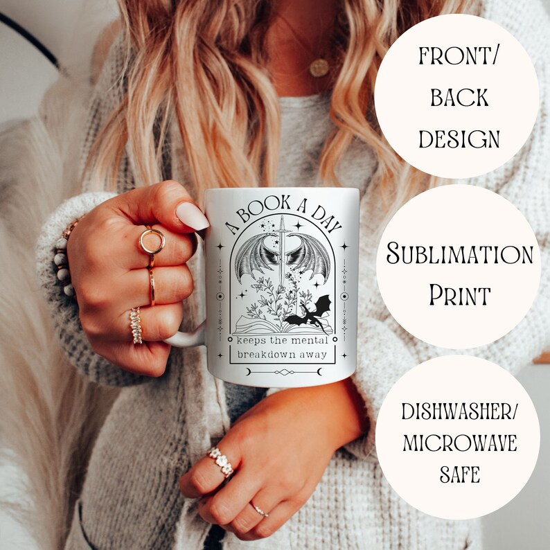 May include: White ceramic mug with a black and white design featuring a dragon, a sword, and the text "A Book A Day Keeps The Mental Breakdown Away".