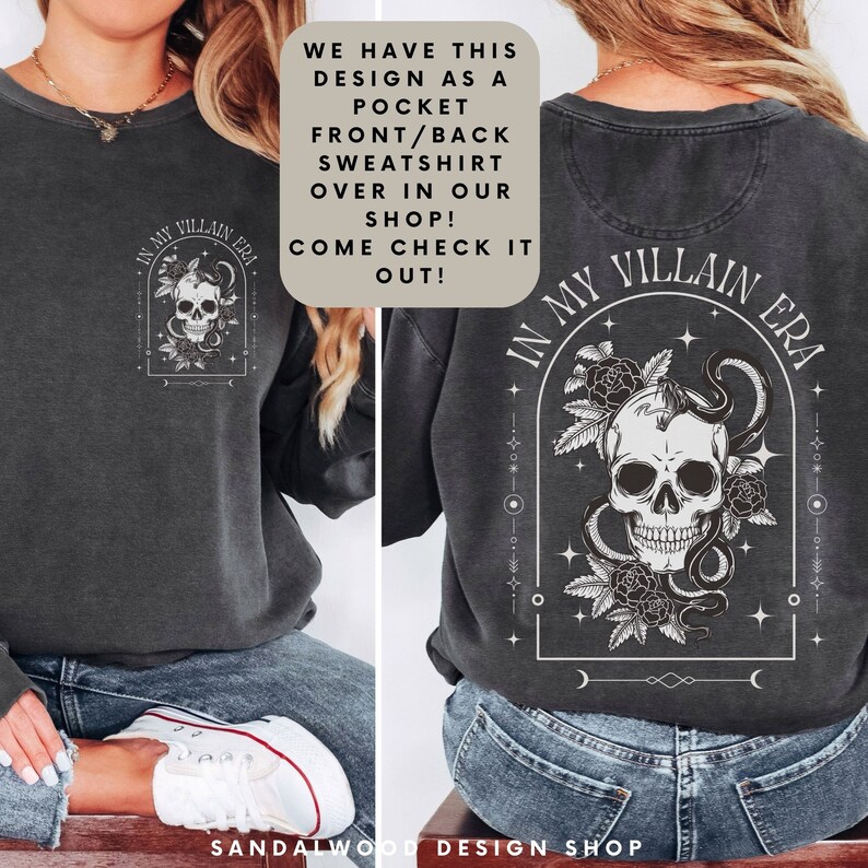 May include: A black sweatshirt with a skull and snake design on the back. The design is surrounded by flowers and stars. The text "In My Villain Era" is written in a gothic font above the skull. The sweatshirt also has a pocket on the front with the same design in a smaller size.