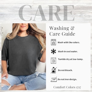 May include: A charcoal grey short-sleeve t-shirt paired with light blue jeans. Next to the shirt is a washing and care guide with icons and text: Wash with like colours, Wash in cool water, Tumble dry at low-temp, Do not bleach, Do not iron design.