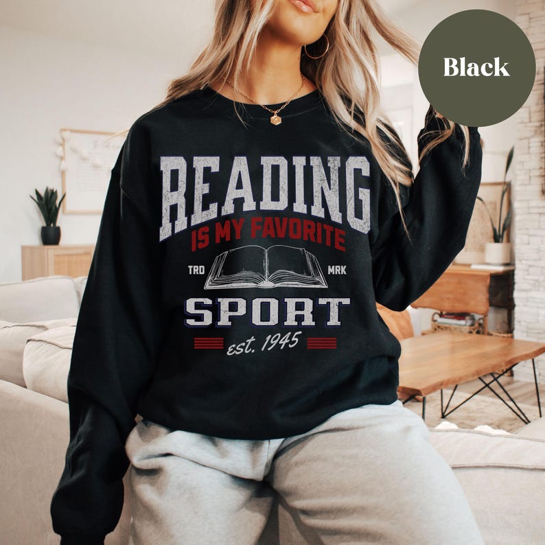 May include: Black sweatshirt with the text "Reading is my favorite sport est. 1945" and a graphic of an open book.