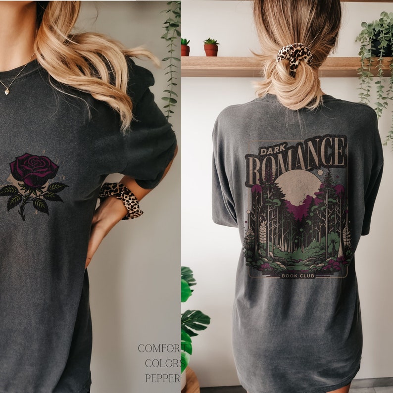 May include: A dark gray oversized t-shirt with a graphic print of a forest scene and the text "Dark Romance Book Club". The front of the shirt features a single rose.